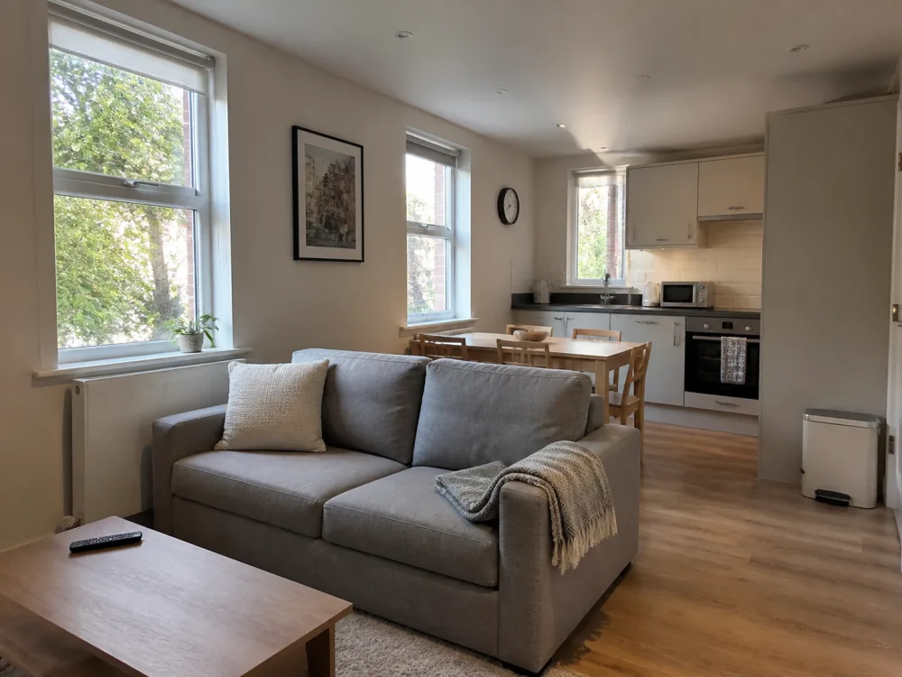 A modern serviced apartment with an open-plan living room and kitchen